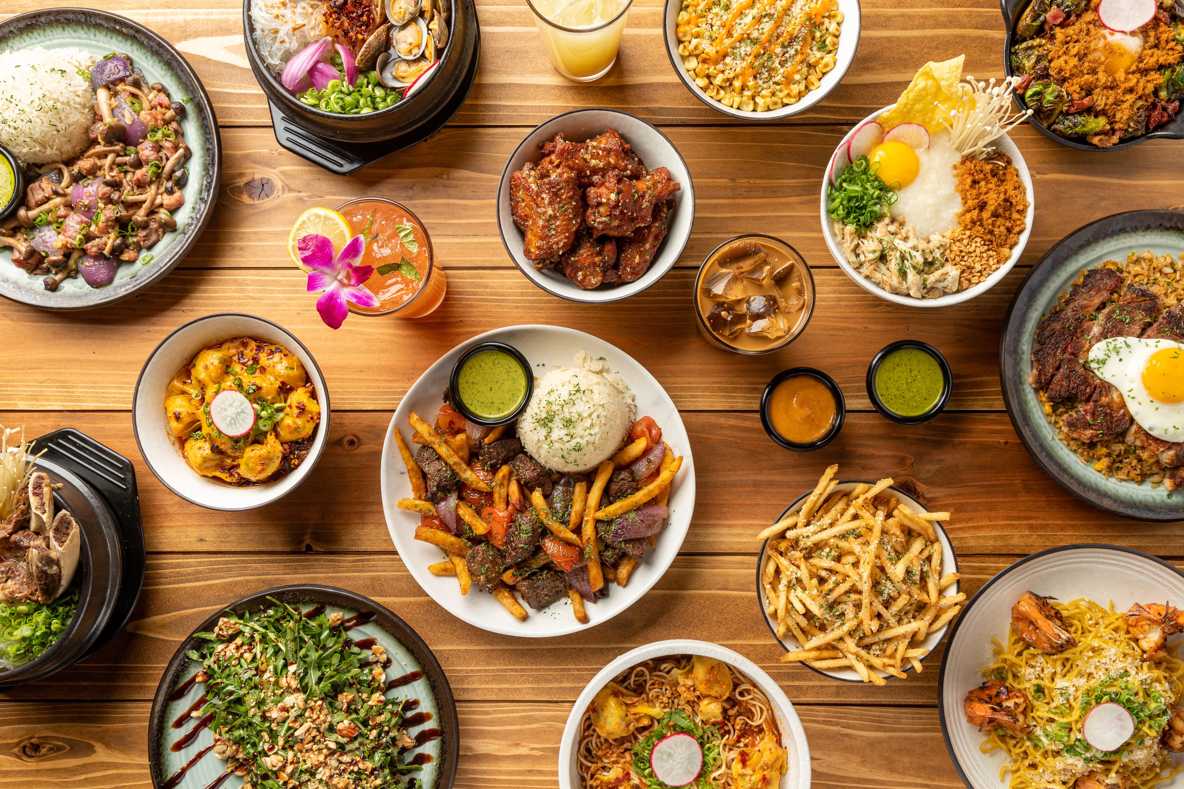 A variety of VOX Kitchen popular dishes such as Lomo Saltado, Pear Salad and Garlic Noodle Ribeye.